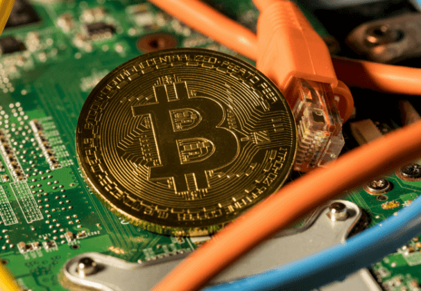 Bitcoin (BTC) is illustrated as a phsyical gold coin on an electric circuit