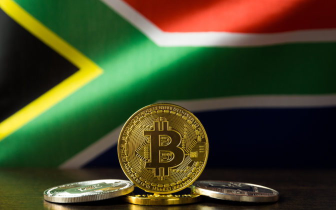 Bitcoin is illustrated as physical coin and the national flag of South Africa