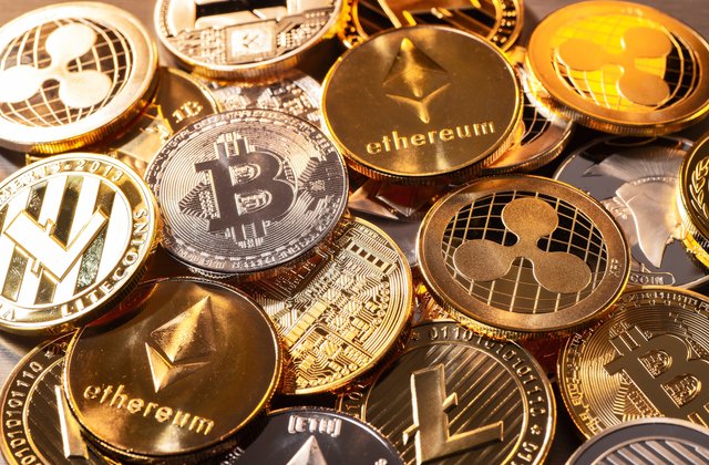Various cryptocurrencies are illustrated as physical gold coins 