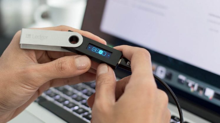 A person is using a Ledger S Nano hardware Bitcoin (cryptocurrency) wallet